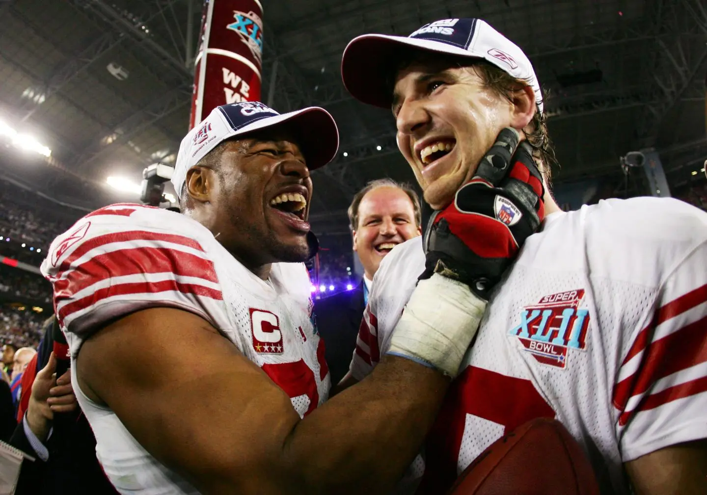 Michael Strahan and New York Giants teammates celebrating Super Bowl XLII victory over the Patriots